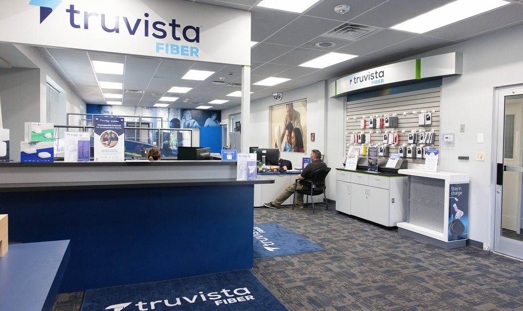 Interior view of the Truvista Fiber customer service office showing service counters, staff desks, and digital displays.